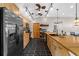 Modern kitchen featuring stainless steel appliances, a large island with sink, stylish lighting, and ample storage at 220 Mountain Creek Rd, Bowdon, GA 30108
