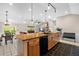Open concept kitchen featuring a large butcher block island, modern appliances, hardwood floors and flows into the living area at 220 Mountain Creek Rd, Bowdon, GA 30108