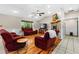 Cozy living room with hardwood floors, vaulted ceiling, and stone fireplace with a large window overlooking a green backyard at 220 Mountain Creek Rd, Bowdon, GA 30108