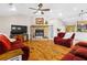 Inviting living room with stone fireplace, hardwood floors, vaulted ceiling, and an open layout perfect for entertaining guests at 220 Mountain Creek Rd, Bowdon, GA 30108
