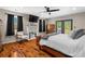 Inviting primary bedroom featuring hardwood floors, a ceiling fan, fireplace, and access to a deck at 220 Mountain Creek Rd, Bowdon, GA 30108