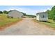 View of the outbuildings on the property and gravel driveway at 220 Mountain Creek Rd, Bowdon, GA 30108