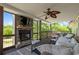Cozy covered patio with a stone fireplace, comfortable seating, and scenic outdoor views at 220 Mountain Creek Rd, Bowdon, GA 30108