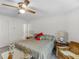 Bedroom with ceiling fan, side tables, and view through to the ensuite bathroom at 3500 Lost Valley Dr, Jonesboro, GA 30236