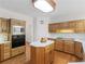 Well-appointed kitchen features an island, stainless steel appliances and wood floors at 3500 Lost Valley Dr, Jonesboro, GA 30236