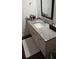 Bathroom featuring a large granite countertop with a white vanity and a mirror at 840 United Se Ave # 408, Atlanta, GA 30312