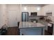 A stylish kitchen features an island, stainless steel appliances, and modern white cabinets at 840 United Se Ave # 408, Atlanta, GA 30312