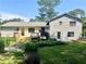 Rear view of the home with a wooden deck, a well-manicured lawn and tasteful landscaping, showcasing its outdoor living space at 1028 Gate Post Ln, Lawrenceville, GA 30044