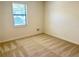 A well-lit bedroom features carpet and a window at 1028 Gate Post Ln, Lawrenceville, GA 30044