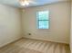 A well-lit bedroom features carpet and a window at 1028 Gate Post Ln, Lawrenceville, GA 30044
