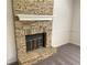 Close-up of a cozy fireplace with a stone surround and white mantle at 1028 Gate Post Ln, Lawrenceville, GA 30044