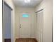 Well-lit foyer featuring wood floors, a closet, and a door with decorative glass at 1028 Gate Post Ln, Lawrenceville, GA 30044