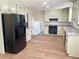 Spacious kitchen features granite counters, stainless steel appliances, wood floors, and painted cabinets at 1028 Gate Post Ln, Lawrenceville, GA 30044