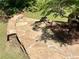 Exterior shot of stone steps leading to the home with a leafy tree in the foreground at 1028 Gate Post Ln, Lawrenceville, GA 30044