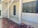 Covered front porch with columns and a small bush in the foreground at 1028 Gate Post Ln, Lawrenceville, GA 30044