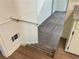 Staircase with gray carpeting and wood accents at 1028 Gate Post Ln, Lawrenceville, GA 30044