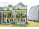 Townhome exterior with private balconies, a well-maintained lawn, and outdoor seating at 3518 Mount Blue Ave, Tucker, GA 30084