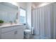 Bright bathroom featuring a white vanity, modern fixtures, and a shower with a stylish curtain at 3518 Mount Blue Ave, Tucker, GA 30084