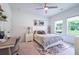 Inviting bedroom with desk, a ceiling fan, and a lovely view out the window at 3518 Mount Blue Ave, Tucker, GA 30084