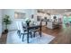 Open concept layout showcasing dining area, kitchen with island, and access to outdoor balcony at 3518 Mount Blue Ave, Tucker, GA 30084
