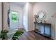 Inviting foyer with coat closet, wood flooring, and decorative table at 3518 Mount Blue Ave, Tucker, GA 30084