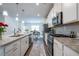 Stylish kitchen showcasing granite counters, white cabinetry, and stainless appliances at 3518 Mount Blue Ave, Tucker, GA 30084