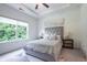Bright main bedroom featuring tray ceilings, large window, and stylish decor at 3518 Mount Blue Ave, Tucker, GA 30084
