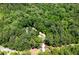 Aerial view of home with circular driveway surrounded by dense trees at 390 Rock Springs Pass, Dallas, GA 30157