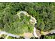 Aerial view of home with circular driveway surrounded by dense trees at 390 Rock Springs Pass, Dallas, GA 30157