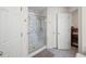 Bathroom highlighting a marble-look shower and convenient towel storage at 390 Rock Springs Pass, Dallas, GA 30157