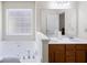 Bathroom featuring a jetted tub and dual sinks, offering a spa-like experience at 390 Rock Springs Pass, Dallas, GA 30157