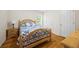 Cozy bedroom featuring hardwood floors, a wooden bed frame, and a blue and white quilt at 390 Rock Springs Pass, Dallas, GA 30157