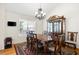 Elegant dining room with a beautiful chandelier, wooden furniture, and large window for natural light at 390 Rock Springs Pass, Dallas, GA 30157