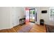 Bright foyer featuring hardwood floors, stylish furnishings, and a vibrant red front door at 390 Rock Springs Pass, Dallas, GA 30157
