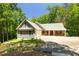 Beautiful exterior showcasing a well-maintained house with a charming front porch and a two-car garage at 390 Rock Springs Pass, Dallas, GA 30157