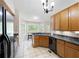 Open kitchen layout with wood cabinets and black appliances, offering backyard views at 390 Rock Springs Pass, Dallas, GA 30157