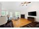 Spacious living room with hardwood floors, a fireplace, vaulted ceilings, and plenty of natural light at 390 Rock Springs Pass, Dallas, GA 30157