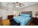 Comfortable main bedroom featuring tray ceiling, hardwood flooring, and ensuite access at 390 Rock Springs Pass, Dallas, GA 30157