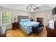 Spacious main bedroom with a tray ceiling, hardwood floors and a ceiling fan at 390 Rock Springs Pass, Dallas, GA 30157