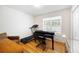 Multi-purpose room featuring a piano, treadmill, and natural light from the window at 390 Rock Springs Pass, Dallas, GA 30157