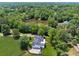 Aerial view of a two-story home nestled among trees, overlooking a serene lake at 471 Henderson Lake Dr, Canton, GA 30115