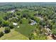 Aerial view showcasing the expansive property with lush lawns, ponds, and well-maintained landscaping at 471 Henderson Lake Dr, Canton, GA 30115