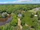 Expansive aerial view of a home with surrounding mature trees, a lake, and a well-manicured lawn at 471 Henderson Lake Dr, Canton, GA 30115