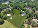Overhead angle of a large estate boasting fenced pastures, a pond, outbuildings, and mature trees at 471 Henderson Lake Dr, Canton, GA 30115