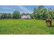 Picturesque backyard with grazing horses and fenced pasture provides a serene, country setting at 471 Henderson Lake Dr, Canton, GA 30115