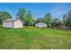 Pastoral scene showcasing two barns in a grassy field, accented by a wooden fence at 471 Henderson Lake Dr, Canton, GA 30115