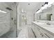 Elegant white bathroom featuring double sinks, a glass-enclosed shower, and marble floors at 471 Henderson Lake Dr, Canton, GA 30115
