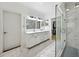 Bright bathroom features double vanity, marble floors, glass shower, and walk-in closet access at 471 Henderson Lake Dr, Canton, GA 30115