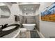 Modern bathroom featuring a soaking tub, sleek black fixtures, and stylish gray tiling at 471 Henderson Lake Dr, Canton, GA 30115