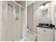 A bathroom features a shower with a clear curtain, a black countertop sink with a vanity, and tiled floors at 471 Henderson Lake Dr, Canton, GA 30115